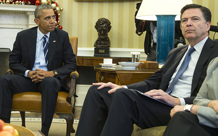 President Barack Obama sits with FBI director James Comey in the Oval Office of the White House in Washington, on Dec. 3, 2015.