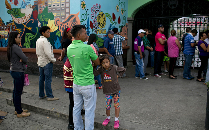Voters wait to enter a polling station during congressional elections in Caracas, Venezuela, Sunday, Dec. 6, 2015. 