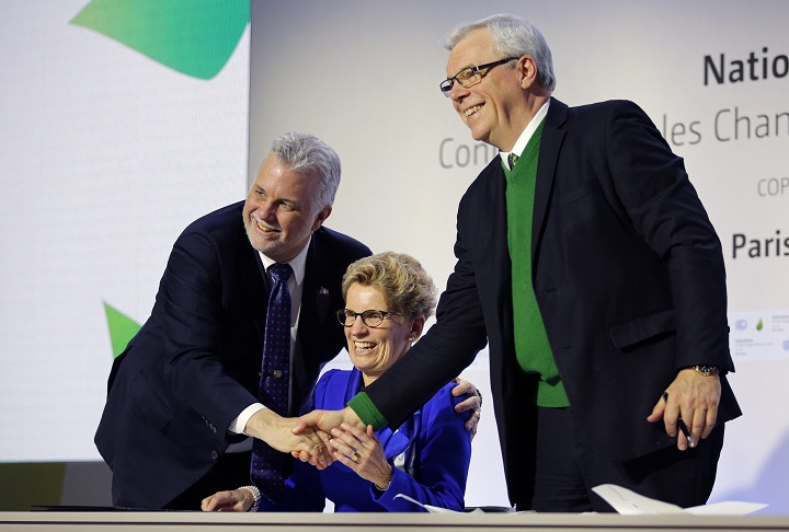 Quebec Premier Philippe Couillard, left, Ontario Premier Kathleen Wynne, center, and Manitoba Premier Greg Selinger shake hands during a signing ceremony at the COP21, the United Nations Climate Change Conference Monday, Dec. 7, 2015 in Le Bourget, north of Paris. The Paris conference is the 21st time world governments are meeting to seek a joint solution to climate change. The talks are focused on reducing emissions of carbon dioxide and other greenhouse gases, primarily by shifting from oil, coal and gas to cleaner sources of energy. (AP Photo/Christophe Ena).