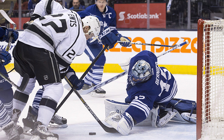 Toronto Maple Leafs goaltender Jonathan Bernier makes a save on Los Angeles Kings' Trevor Lewis during first period NHL hockey action in Toronto on Saturday December 19, 2015. 