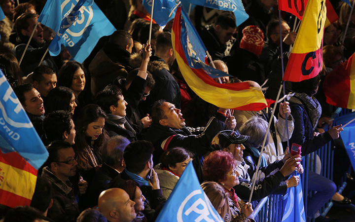 Popular Party supporters shout slogans outside the party's headquarters following the national elections in Madrid, Sunday, Dec. 20, 2015. 