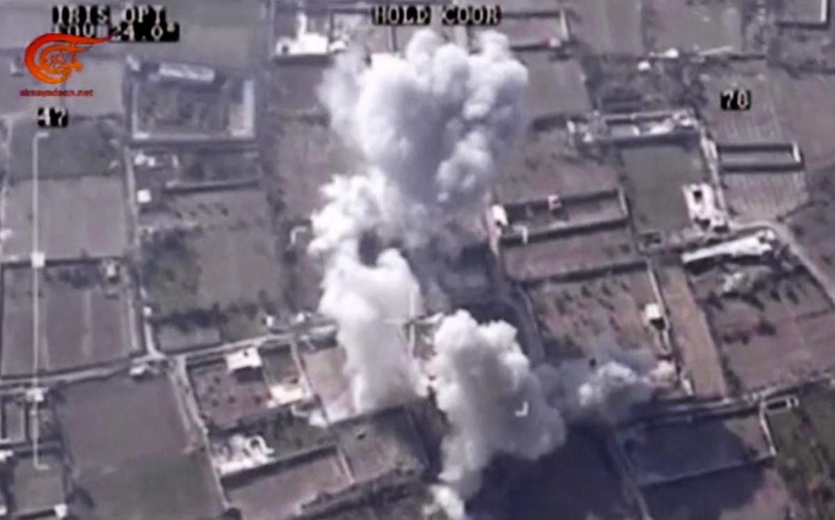 This image made from video made available on Saturday, Dec. 26, 2015, by Al-Mayadeen, government-controlled Syrian Television, which has been verified and is consistent with other AP reporting shows, drone footage allegedly showing Syrian army airstrikes targeting Zahran Allouch, the head of the Army of Islam group near Damascus, Syria.