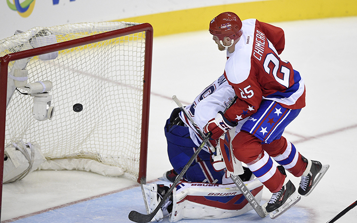 Washington Capitals left wing Jason Chimera scores a goal against Montreal Canadiens goalie Mike Condon during the third period of an NHL hockey game, Saturday, Dec. 26, 2015, in Washington. The Capitals won 3-1. 