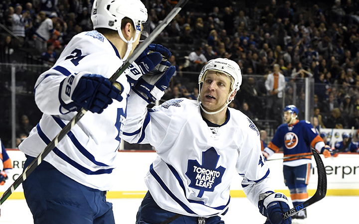 Toronto Maple Leafs left wing James van Riemsdyk celebrates his empty net goal with Toronto Maple Leafs center Leo Komarov during the third period of an NHL hockey game against the New York Islanders on Sunday, Dec. 27, 2015, in New York. The Maple Leafs won 3-1.