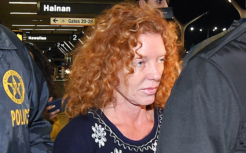Tonya Couch, center, is taken by authorities to a waiting car after arriving at Los Angeles International Airport, Thursday, Dec. 31, 2015, in Los Angeles. 