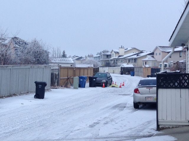 Calgary police investigate a fatal shooting in alley in the 100 block of Del Ray Road N.E. on Sunday, Dec. 13, 2015.