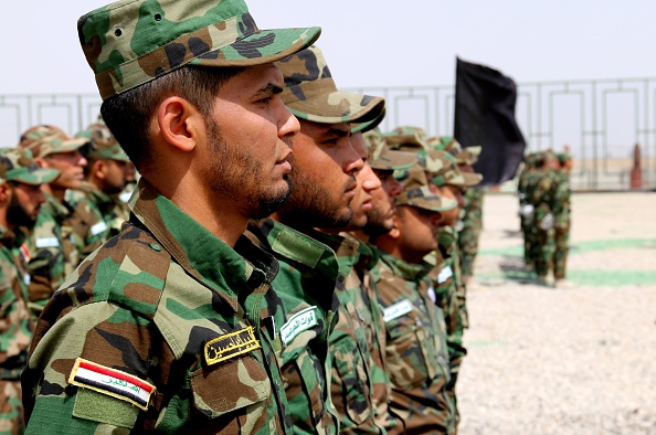 A part of Turkmen volunteer soldiers are seen during a graduation ceremony following a military drill as they have completed their military trainings to fight against Daesh (Islamic State of Iraq and the Levant) terrorists, in Tuzhurmatu district of Saladin province, Iraq on May 11, 2015. (Photo by Ali Mukarrem Garip/Anadolu Agency/Getty Images).