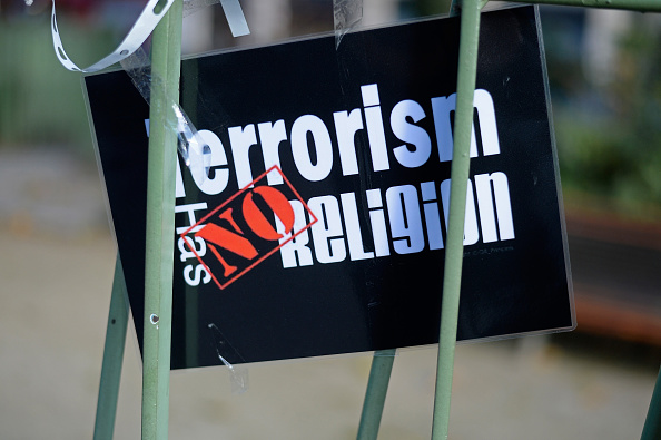A 'Terrorism has no religion' sign can be seen in front of the Bataclan as people continue to leave tributes to victims at attack sites in Paris on December 4, 2015 in Paris, France. On Friday, November 13th, 130 people lost their lives after the most deadly terrorist attack in French history.  (Photo by Aurelien Meunier/Getty Images).