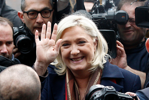 French far-right Front National (FN) party's president and FN candidate for the regional election in the Nord-Pas-de-Calais-Picardie region, Marine Le Pen, waves after voting of the regional elections on December 13, 2015 in Henin-Beaumont, France. France is holding its second round of the regional elections.  (Photo by Chesnot/Getty Images).