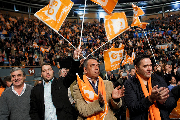 Supporters of Ciudadanos (Citizens) party cheer during a campaign rally with Albert Rivera at Palacio de Vistalegre on December 13, 2015 in Madrid, Spain. Spain goes to the polls on December 20, 2015 in general elections to elect 350 members of parliament and 208 senators. After three decades of two party monopoly at the Spanish Parliament, polls predict tightest results ever of four parties. Left wing party Podemos and Center-right party Ciudadanos have risen this year changing the politics in Spain. The governing right wing People's party is expected to gain the most votes, despite public discontent over corruption and social cuts.  (Photo by Pablo Blazquez Dominguez/Getty Images).