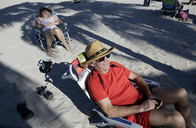 Tourist Robert Tembley, 61, of Montreal, relaxes on the beach in Hollywood, Fla., in Nov. 2015.