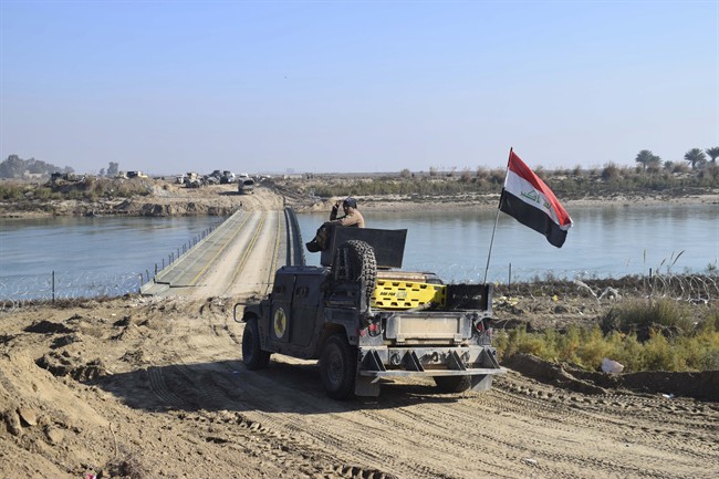 Iraqi security forces cross a bridge built by corps of Engineers over the Euphrates River as Islamic State destroyed all the bridges leading to central Ramadi to block Iraqi security forces from moving forward in Ramadi, 115 kilometers west of Baghdad, Iraq, Tuesday, Dec. 22, 2015.  (File photo).
