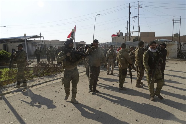 Iraqi security forces enter the government complex in central Ramadi, 70 miles (115 kilometers) west of Baghdad, Iraq, Monday, Dec. 28, 2015.
