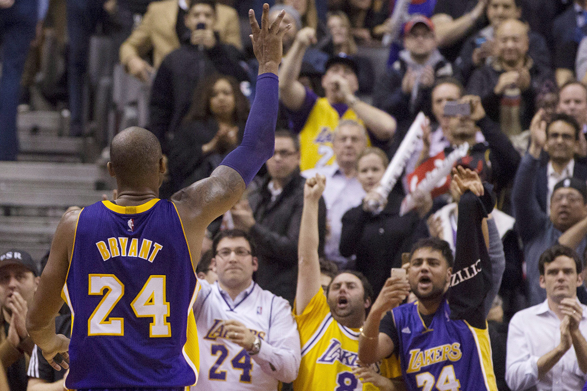 Los Angeles Lakers's Kobe Bryant gestures to the crowd as he returns to the bench in the final seconds of the second half.