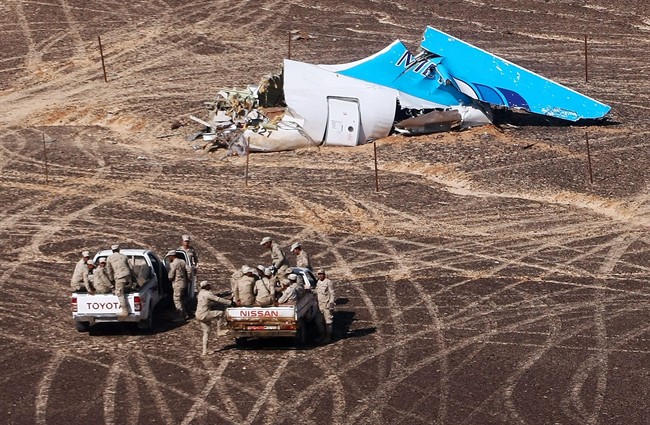 FILE - In this Sunday, Nov. 1, 2015 photo provided by Russian Emergency Situations Ministry, Egyptian Military on cars approach a plane's tail at the wreckage of a passenger jet bound for St. Petersburg in Russia that crashed in Hassana, Egypt. Egypt's chief investigator says a preliminary investigation into the October crash of a Russian passenger plane in Sinai has found no indication yet of any "illegal or terrorist act." (Maxim Grigoriev/Russian Ministry for Emergency Situations via AP, File).