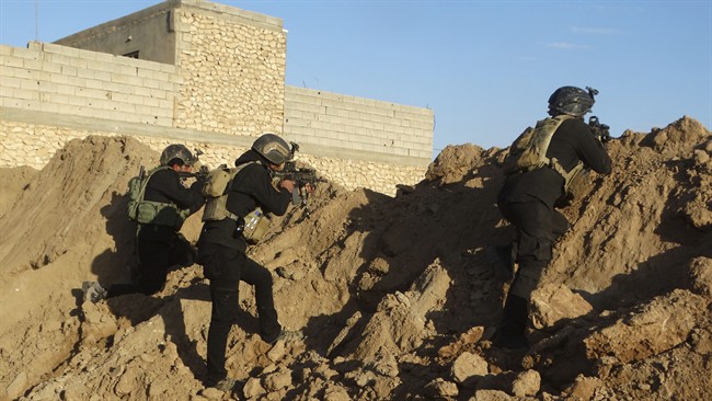 Iraqi security forces take combat position at the front-line as during the siege of Ramadi, the capital of Iraq's Anbar province on Nov. 30, 2015.
