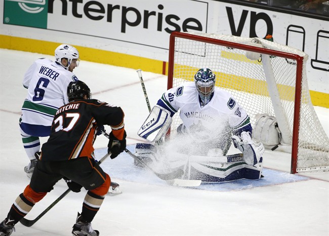 Anaheim Ducks left wing Nick Ritchie fires a shot that is deflected by Vancouver Canucks goalie Ryan Miller during the first period of a NHL hockey game Monday, Nov. 30, 2015, in Anaheim, Calif. 