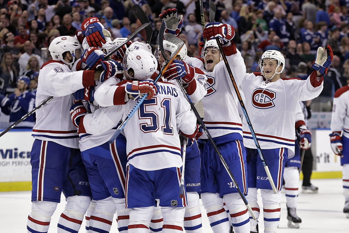 Members of the Montreal Canadiens mob Max Pacioretty after his goal against the Tampa Bay Lightning during the shootout in an NHL hockey game Monday, Dec. 28, 2015, in Tampa, Fla. 