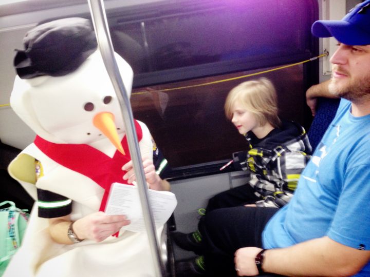 Frosty the Snowman joins some young pediatric care patients for a ride on the “Candy Cane Express” Wednesday night.