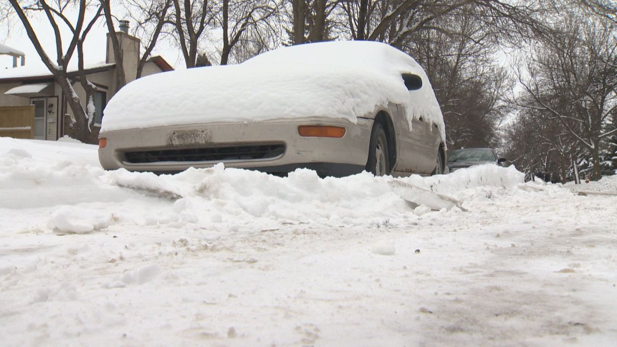 Car surrounded by snow during residential plowing operation.  December 21, 2015.