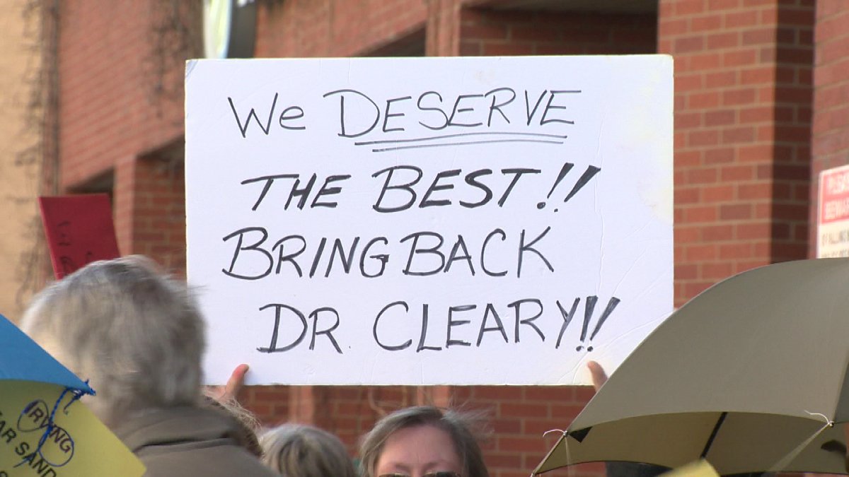 People protested Dr. Cleary's leave outside HSBC Place in Fredericton.
