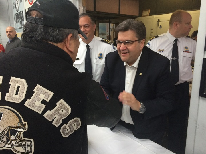 Montreal Mayor Denis Coderre handing out food bags at Sun Youth.