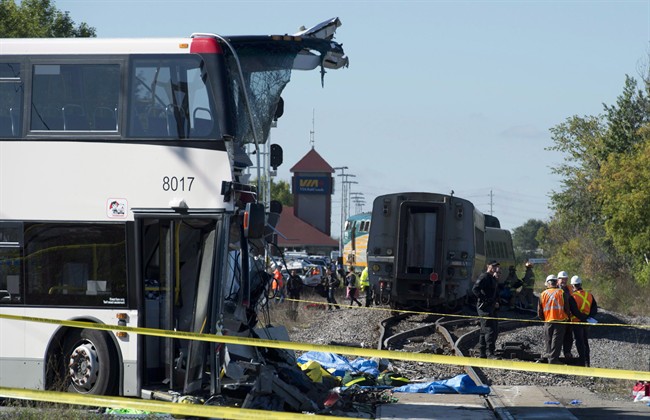 An OC Transpo bus sits where it collided with a Via Rail train during the morning commute, Wednesday September 18, 2013 in Ottawa. 