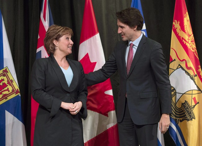 Prime Minister Justin Trudeau speaks with B.C. Premier Christy Clark as he officially welcomes her to the First Ministers meeting at the Museum of Nature, in Ottawa, on November 23, 2015. 