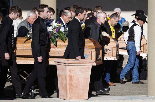 Pall bearers carry the three coffins of Catie Bott, who was 13, and her twin 11-year-old siblings, Jana and Dara Bott in Red Deer, Alta., Friday, Oct. 23, 2015. The girls suffocated when they became buried in the back of a truck filled with canola on a farm near Withrow, Alta. Glen Blahey with the Canadian Agricultural Safety Association says the tragedy has acted as a catalyst for discussing child safety on farms. 