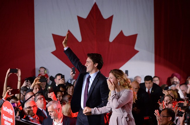 Prime Minister Justin Trudeau makes his way to the stage with wife Sophie Gregoire-Trudeau at Liberal party headquarters, in Montreal, on October 20, 2015.