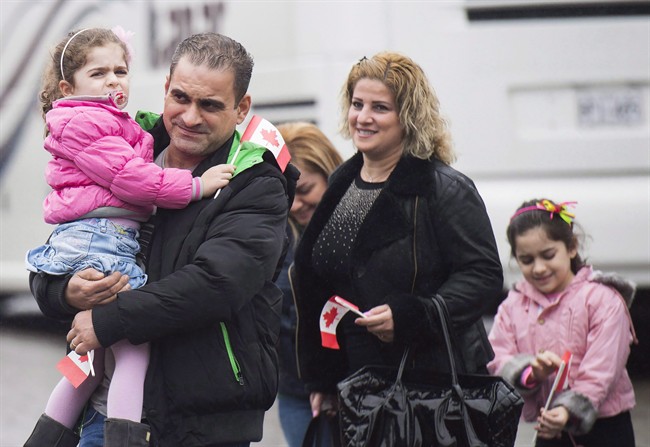 Newly-arrived Syrian refugees meet sponsors and relatives at the Armenian Community Centre in Toronto on Wednesday, December 16, 2015. The federal government appears likely to miss its latest target to resettle 10,000 Syrians by the end of this year.