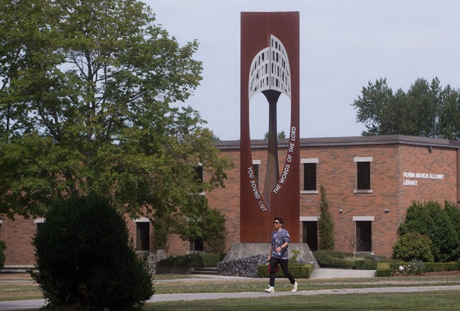 FILE PHOTO: A student walks past the bell tower at Trinity Western University in Langley, B.C.,.