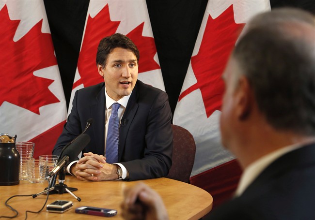 Prime Minister Justin Trudeau speaks with reporters during an interview with The Canadian Press in Ottawa on Wednesday, December 16, 2015. Ensuring Canadians have access to federal information will mean more â€” and sometimes difficult â€” public scrutiny, but ultimately it will lead to better government, the prime minister says. 