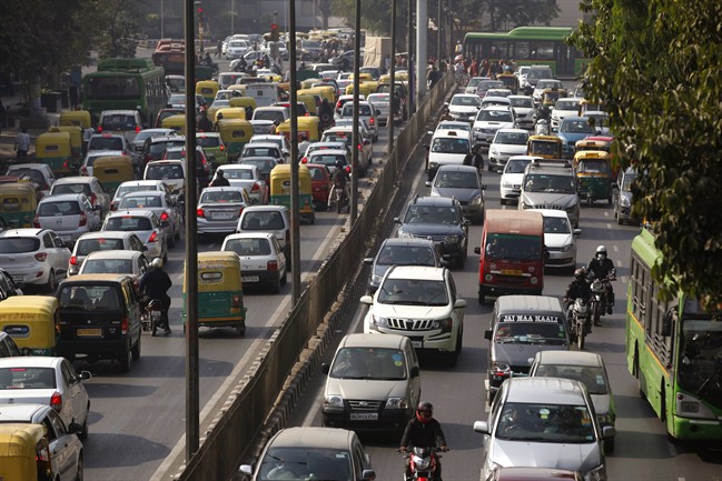 Cars and buses clogs a road in New Delhi, India, Wednesday, Dec. 16, 2015. India's top court Wednesday ordered a temporary ban on the sale of large diesel vehicles in and around New Delhi and slapped a stiff levy on trucks entering the capital as it struggles with record pollution. (AP Photo/Tsering Topgyal).