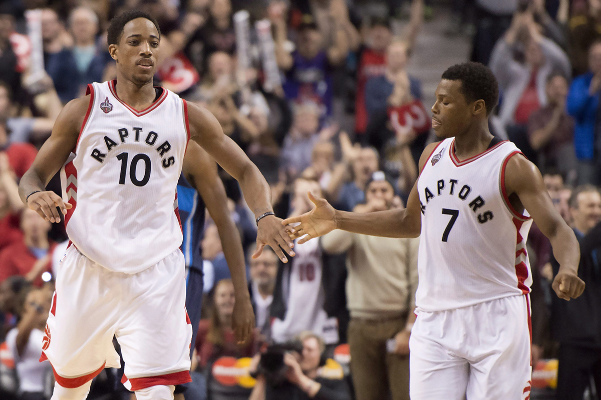 Toronto Raptors guards DeMar DeRozan (left) and Kyle Lowry congratulate each other in the dying seconds of a 103-99 win over the Dallas Mavericks.