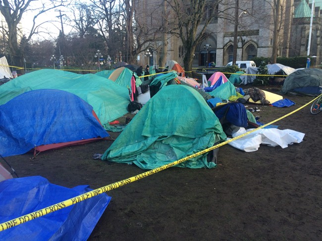 FILE PHOTO: A section of Victoria's downtown homeless camp on the courthouse lawn is seen behind police tape on Thursday, Dec. 24, 2015.