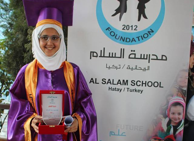 Dunia Al Melhm holds her diploma after graduating from Al Salam School in Turkey.