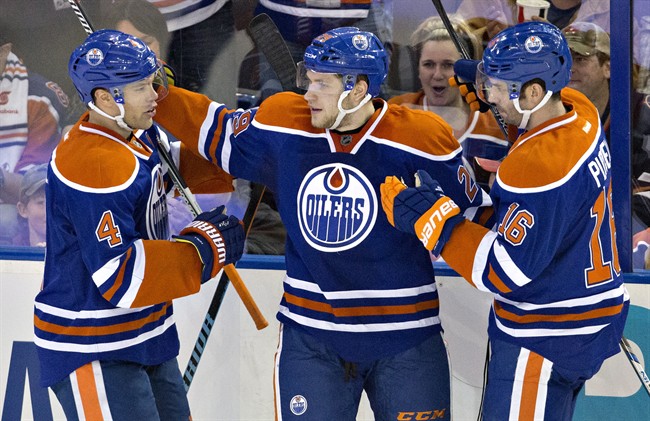 Edmonton Oilers' Taylor Hall (4), Leon Draisaitl (29) and Teddy Purcell (16) celebrate a goal against the San Jose Sharks during second period NHL action, in Edmonton, on Wednesday, Dec. 9, 2015. Riding the wave of a four-game winning streak, the Oilers are discovering a new sense of confidence and a winning mentality.