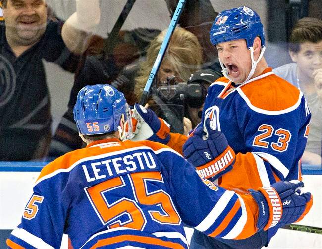 Edmonton Oilers' Matt Hendricks (23) and Mark Letestu (55) celebrate a goal against the Boston Bruins during second period NHL action in Edmonton, Alta., on Wednesday December 2, 2015.