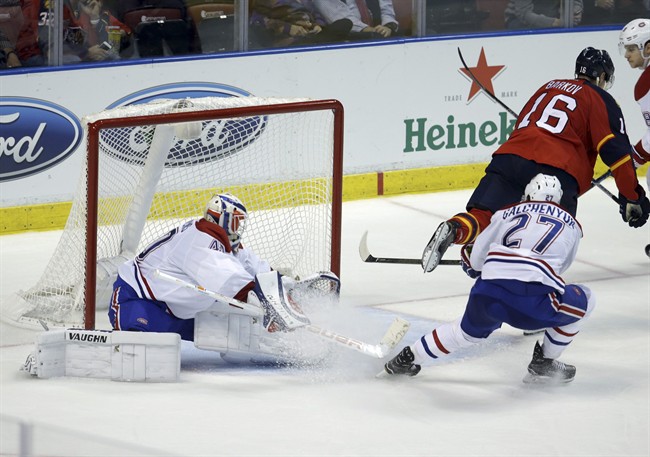 The puck gets past Montreal Canadiens goalie Ben Scrivens, left, on a goal scored by Florida Panthers center Aleksander Barkov (16) during the third period of an NHL hockey game, Tuesday, Dec. 29, 2015, in Sunrise, Fla. The Panthers defeated the Canadiens 3-1.