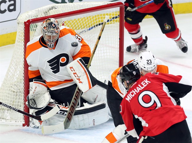 Goalie Steve Mason makes a chest save during a game against the Ottawa Senators on Dec. 1, 2015.