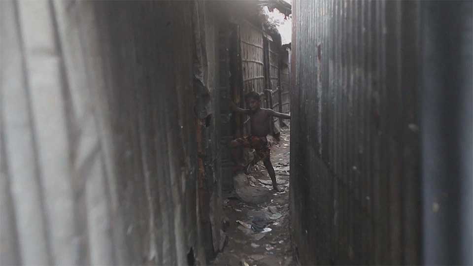 A climate-displaced boy takes shelter in a shantytown in Dhaka on October 18, 2015.