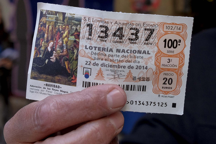 An employee from Madrid's wax museum in Madrid shows a first prize ticket in Spain's Christmas lottery named "El Gordo" (Fat One) in Madrid on December 22, 2014.