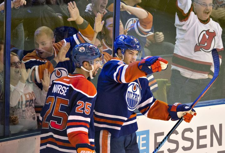Edmonton Oilers' Darnell Nurse (25) and Taylor Hall (4) celebrate a goal on the San Jose Sharks during overtime NHL action, in Edmonton, on Wednesday, Dec. 9, 2015. 