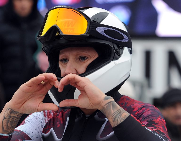 Kaillie Humphries of Canada makes a heart shape with her hands as she celebrates coming third in the women's competition of the women's competition of the bobsleigh world cup in Winterberg, Germany, 5 December 2015. 