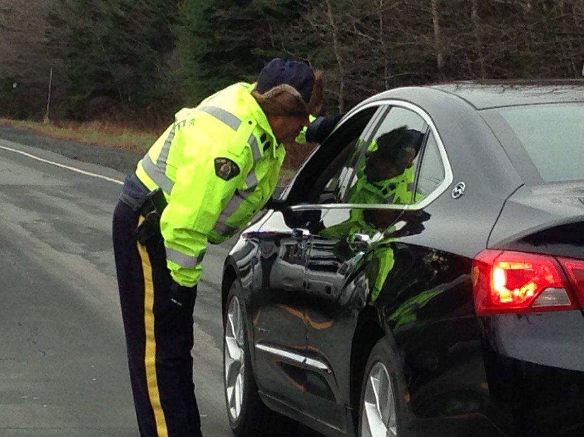 An RCMP officer speaks to a driver as part of a checkpoint in Cole Harbour on Friday.