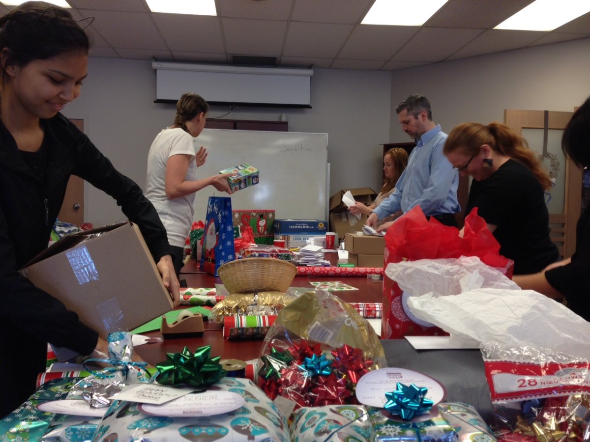 Volunteers hard at work wrapping up gifts for seniors.