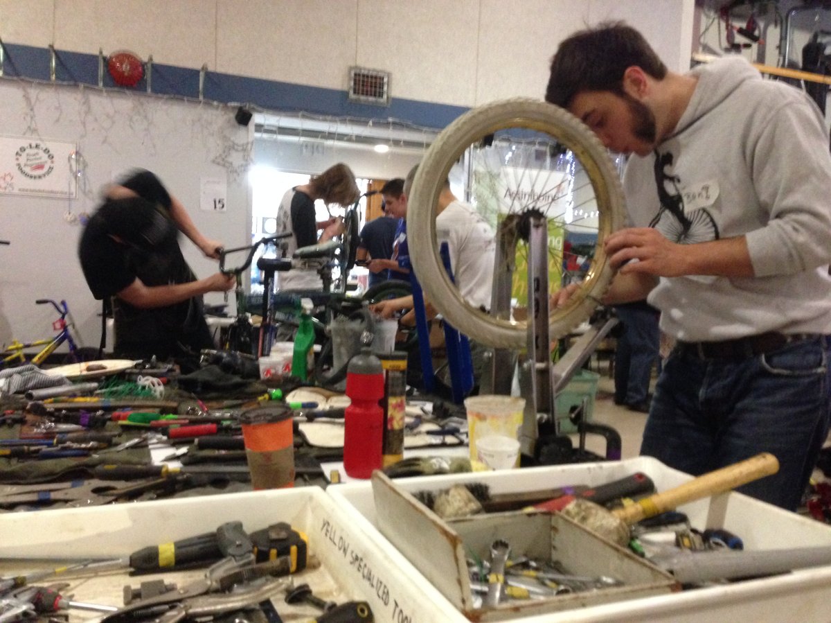Volunteers hard at work (and light on sleep) building bikes for Winnipeg children.
