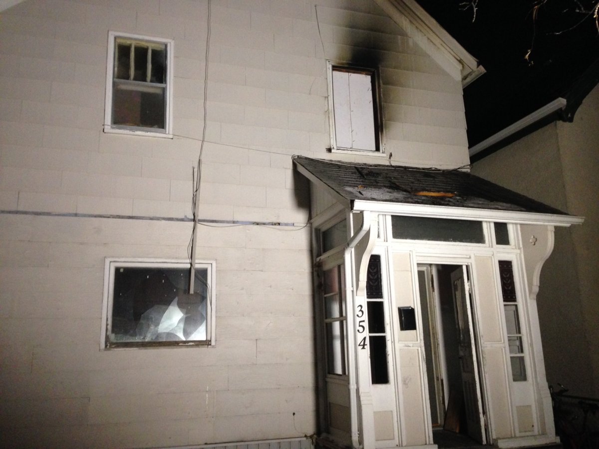 Woman rescued after hanging from top floor window during Elgin Avenue house fire Monday night. 