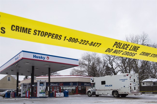 Homicide detectives investigate at a Mac's convenience store in Edmonton on Friday, December 18, 2015.